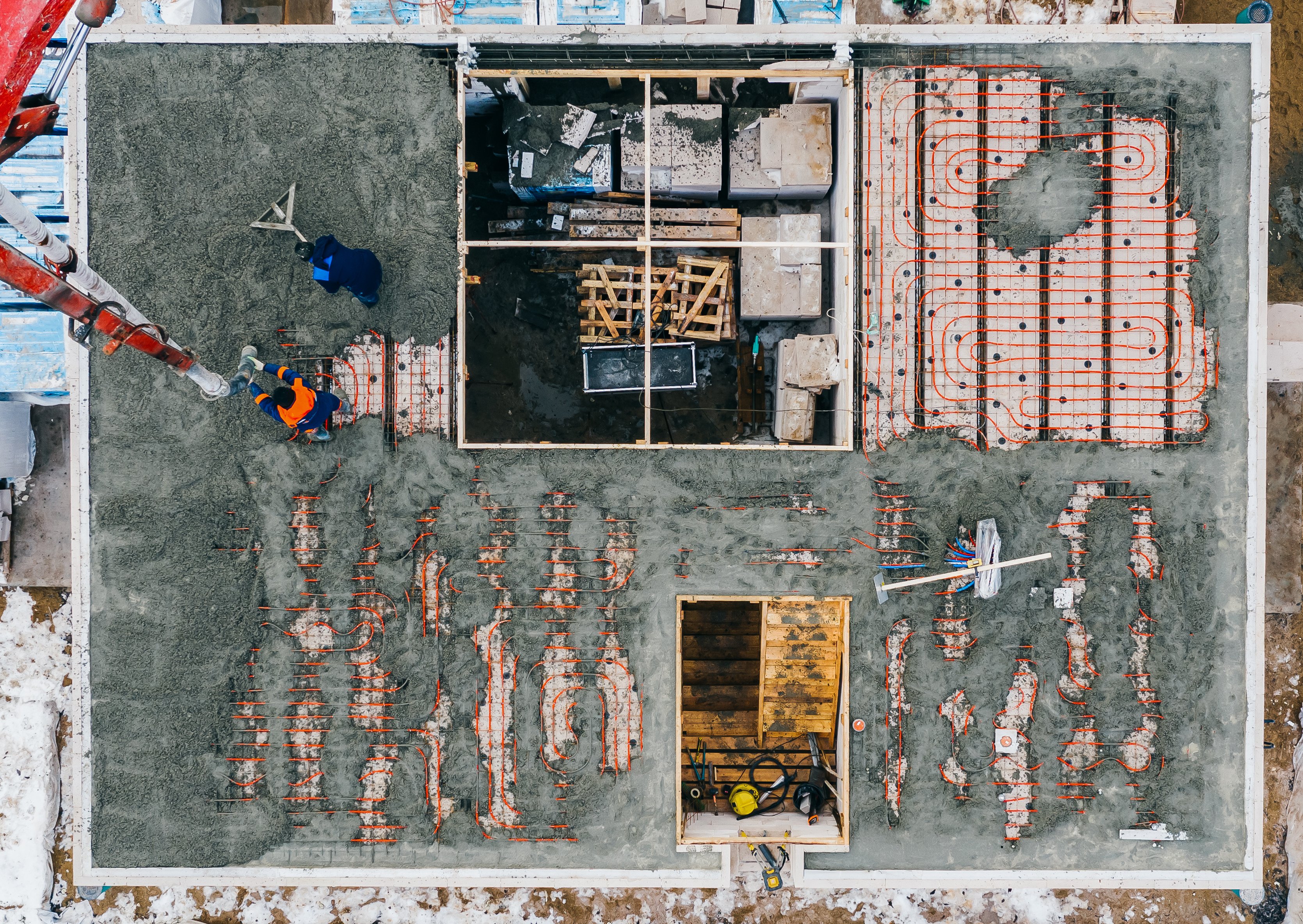 aerial-view-of-construction-workers-pouring-a-wet-2023-11-27-05-00-20-utc